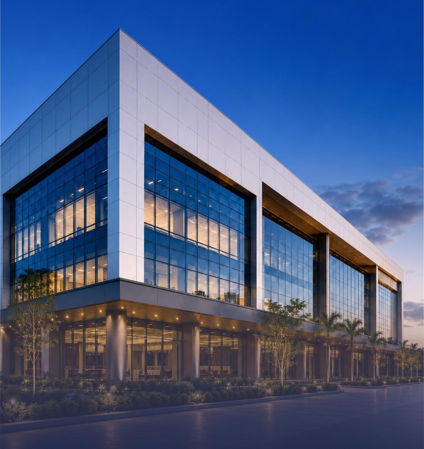 Glass curtain-wall office building facade at dusk